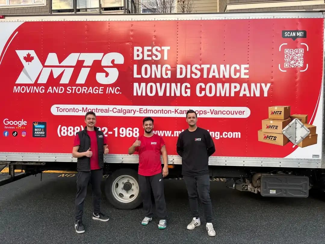 MTS moving crew in front of long distance moving truck
